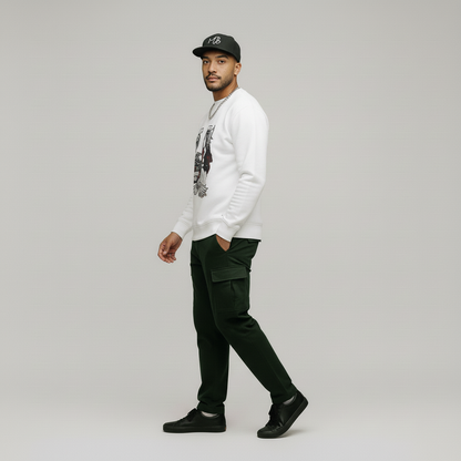 Man wearing a white sweatshirt, black cap, and dark pants on a gray background